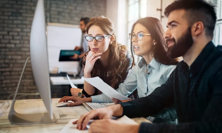 co-workers looking at computer screen