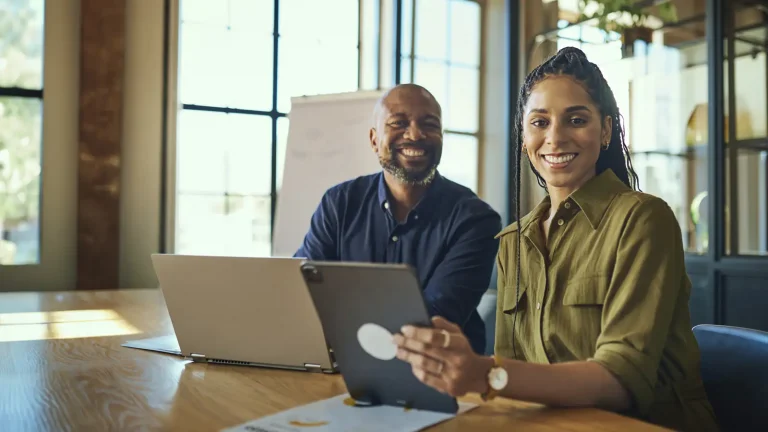 Co-workers using gen ai in tablet and laptop