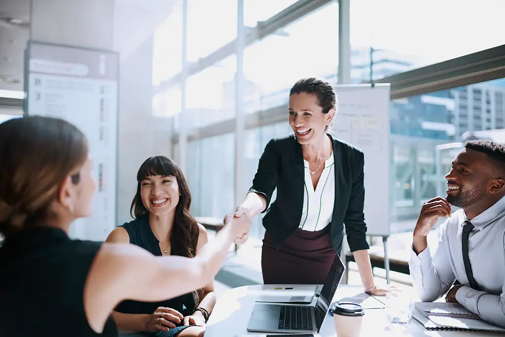 asset-management-1143297164 colleagues shaking hands in a meeting